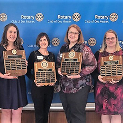 Educators of the year standing together holding their plaques